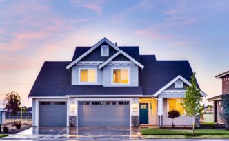 Beautiful modern suburban home with a pristine new roof, showcasing excellent curb appeal on a bright, sunny day.