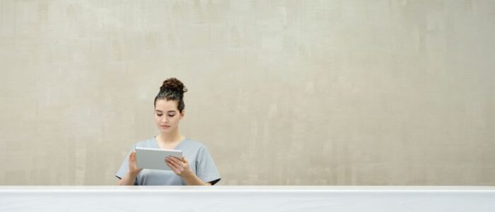 Professional real estate leader calmly using a tablet in a bright, modern office, symbolizing control and smart automation.